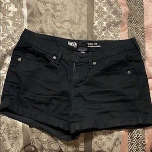 A mid-rise midi black pair of shorts.